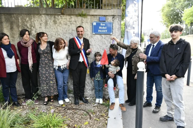 Groupe inaugurant la plaque Rue Michel Passet avec un maire portant son écharpe tricolore.