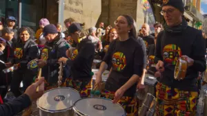 Un groupe de musiciens jouant des percussions dans une rue animée de Tours.